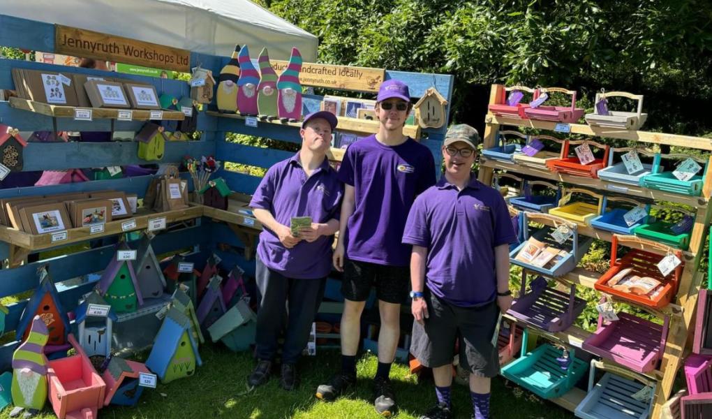 Three Jennyruth Workshops representatives standing in front of a stall