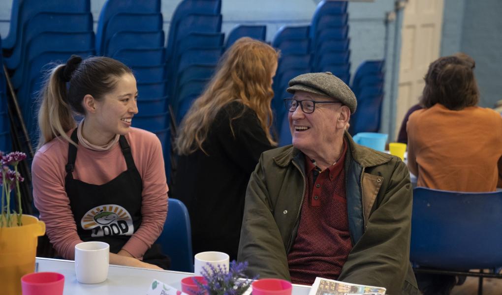 Two smiling FoodCycle representatives enjoying a cup of tea