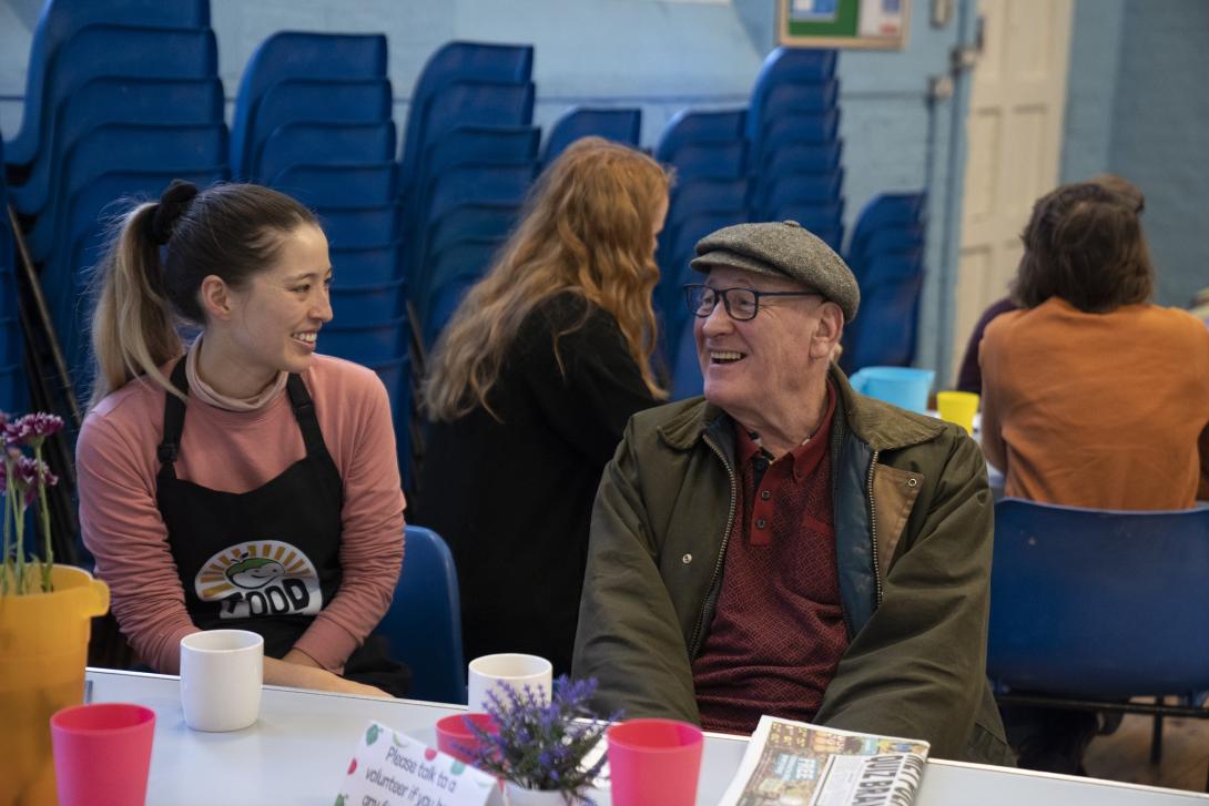 Two smiling FoodCycle representatives enjoying a cup of tea