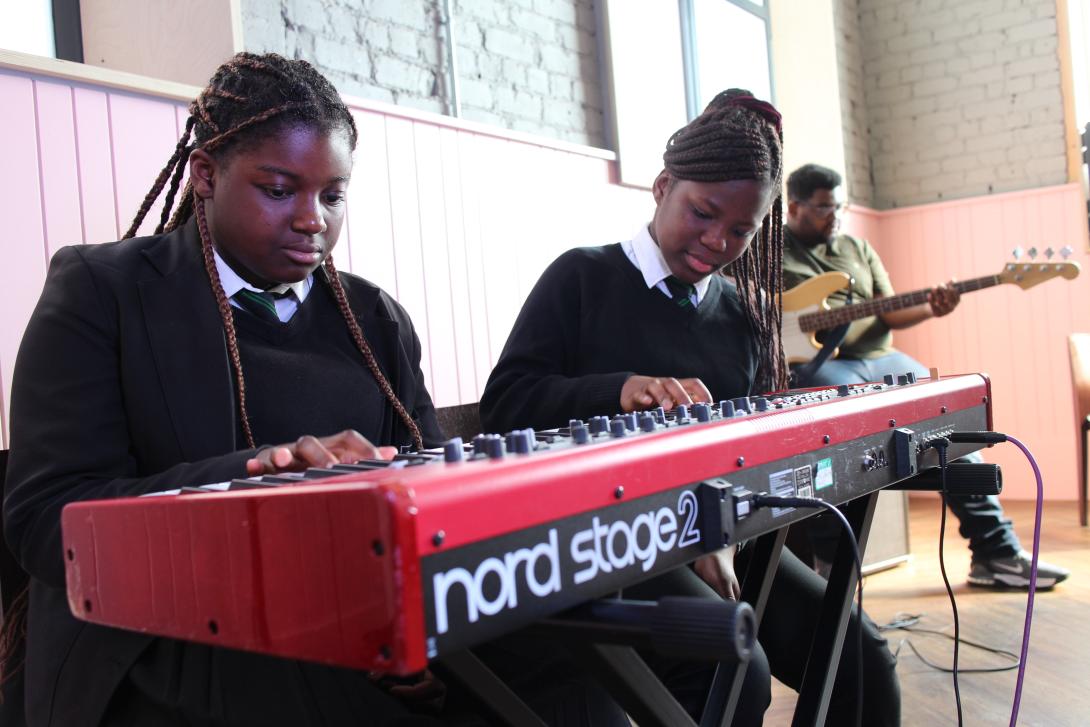 Two school pupils playing a Nord Stage 2 keyboard