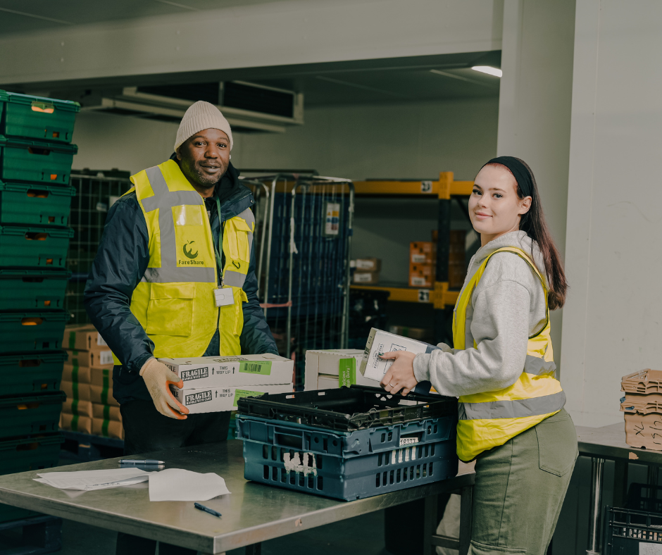 Two warehouse volunteers handling deliveries